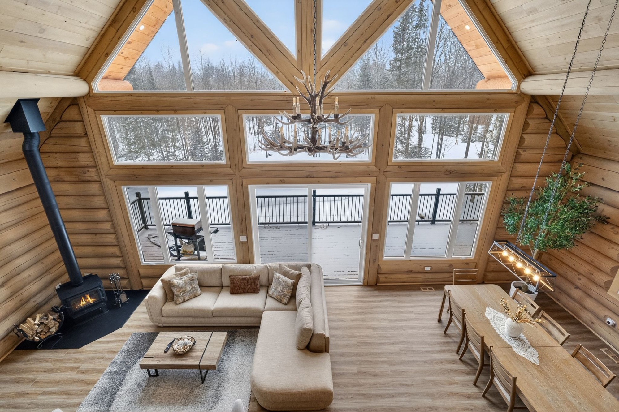 Cathedral living room with fireplace and antler chandelier